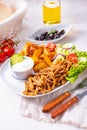 Gyros plate it green salad ,olives and potato wedges Royalty Free Stock Photo