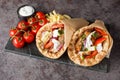 Gyros souvlaki wrapped in a pita bread closeup on the board. Horizontal Royalty Free Stock Photo