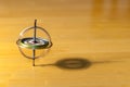 Gyroscope spinning and balancing on a wooden table