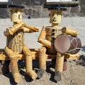 Gyumri, Shirak province / Armenia - september 1, 2020. two people from a tree play a flute and a drum. Wooden doll. Musical