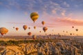 GÃÂ¶reme, Cappadocia, Turkey - October 7 2019:  Hot air balloons filled with tourists at sunrise floating along valleys of GÃÂ¶reme Royalty Free Stock Photo