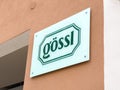 GÃ¶ssli storefront sign on textured wall in urban setting Royalty Free Stock Photo