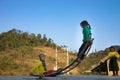 Ha Giang, Vietnam - Feb 14, 2016: Ethnic minority H`mong children play seesaw made of curved metal rod. Most of Hmong households