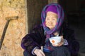 Ha Giang, Vietnam - Feb 14, 2016: Portrait of old Hmong woman having meal on door step in Van district