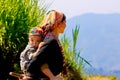 Ethnic mom and her child on the mountain near ripen rice terraces. Royalty Free Stock Photo