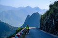 Ha Giang / Vietnam - 01/11/2017: Motorbiking backpackers on winding roads through valleys and karst mountain scenery in the North