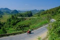 Ha Giang / Vietnam - 01/11/2017: Motorbiking backpackers on winding roads through valleys and karst mountain scenery in the North Royalty Free Stock Photo