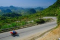 Ha Giang / Vietnam - 01/11/2017: Motorbiking backpackers on winding roads through valleys and karst mountain scenery in the North Royalty Free Stock Photo