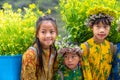 Ha Giang, Vietnam - Nov 24, 2018: Ethnic minority children with flower basket on back in Quan Ba district