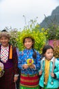 Ethnic minority children with flower basket on back in Quan Ba district