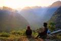 Ha Giang / Vietnam - 01/11/2017: Two local Vietnamese women in traditional clothes looking at the sunrise and mountain scenery in