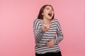 Ha ha, you`re ridiculous! Portrait of woman in striped sweatshirt pointing fingers to camera and laughing out loud