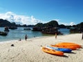 Kayaks, boats and tourists on a beach on Monkey Island in Ha Long Bay. Vietnam