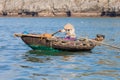 Ha Long Bay, Vietnam. Vietnamese woman rowing boat Royalty Free Stock Photo