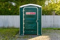Haapsalu, Estonia, 14.07.2020, A Green Portable Toilet in a Park for events, rentedby Cramo rent.