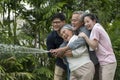 Haapy Asian family feel smil lovely are watering a tree by tube in garden at outdoor house in morning