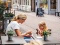 Mother and daughter eating icecream at the terrace of the Chocolaterie Pierre