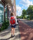 Side view of young tourist woman with a backpack discovering the Dutch city of