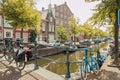 HAARLEM, NETHERLANDS, AUGUST 2019: Canal with historic houses in old Haarlem, the Netherlands, with lilac flowers. Europe tourism