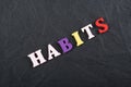 HABITS word on black board background composed from colorful abc alphabet block wooden letters, copy space for ad text. Learning