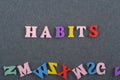 HABITS word on black board background composed from colorful abc alphabet block wooden letters, copy space for ad text. Learning