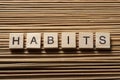 HABITS word written on wood abc block at wooden background Royalty Free Stock Photo