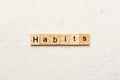 HABITS word written on wood block. HABITS text on cement table for your desing, concept