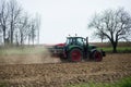 view of tractor preparing the land in a field landscape