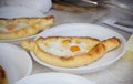 Hachapuri baked with egg yolk on a plastic plate