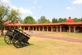 Hacienda colonnial country house, stone construction arches and wooden cart on the lawn