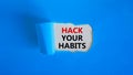 Hack your habits symbol. Words `Hack your habits` appearing behind torn blue paper. Beautiful blue background. Business,