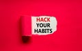 Hack your habits symbol. Words `Hack your habits` appearing behind torn purple paper. Beautiful purple background. Business,