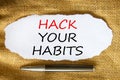 Hack your habits symbol. Words `Hack your habits` on white paper. Black metallic pen. Beautiful canvas background. Business,