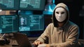 Hacker with anonymous mask breaking security system Royalty Free Stock Photo