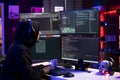Hacker in apartment listening music, coding malware Royalty Free Stock Photo