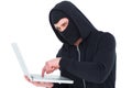 Hacker in balaclava typing on laptop Royalty Free Stock Photo