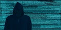 Hacker in black hood Shows the extraction through binary. Stand in front of a code background with binary streams and information Royalty Free Stock Photo
