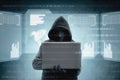 Hacker in black hoodie holding laptop and virtual screen display the server data, binary code, bar graph and world map Royalty Free Stock Photo