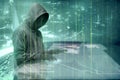 Hacker in black hoodie touching virtual screen on the table with server data, binary code, bar graph and world map Royalty Free Stock Photo