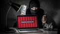 Hacker with computer screen showing ransomware attacking Royalty Free Stock Photo