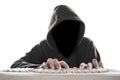 Hacker with dark face typing on computer keyboard Royalty Free Stock Photo