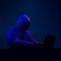 Hacker in dark. Hooded figure on computer. Cyber security person. Black hat hacking. Neon light theme. Vector illustration.
