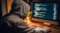 Hacker in Dark Hoodie Working on Computer Coding in Low Light Environment Royalty Free Stock Photo