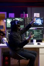 Hacker at desk coding on PC, using virtual reality to evade security Royalty Free Stock Photo