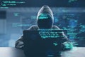 Hacker at desk using laptop with creative coding html language on blurry office interior background. Web developer, hacking,
