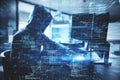 Hacker at desktop using computer with creative glowing coding big data interface on dark interior background. Technology and Royalty Free Stock Photo