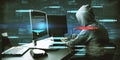 Hacker at desktop using computers with abstract glowing big data blockchain interface on dark background. Cryptocurrency, finance Royalty Free Stock Photo