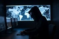 Hacker dressed in a hoodie, sitting in a dark room surrounded by monitors, coding malicious software. Ai generated