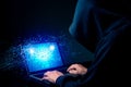 Hacker exploits AI-chip on a laptop in a dark cyber-security scene. Royalty Free Stock Photo