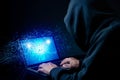 Hacker exploits AI-chip on a laptop in a dark cyber-security scene. Royalty Free Stock Photo